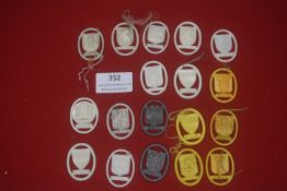 A group of German plastic WHW donation badges, oval form, depicting city and regional coats of