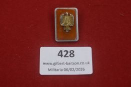 German Red Cross (DRK) rectangular enamel membership badge, with gilt eagle and cross device on a