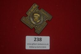 German political or commemorative badge, cross-form example with central profile portrait and