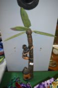 Carved African Figure Climbing a Palm Tree