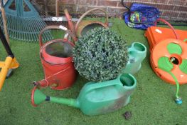 Assorted Watering Cans and an Artificial Plant