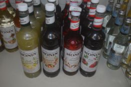 *4x Bottles of Assorted Monin Syrups: 1L Strawberry, 1L Peach, 1L Lemon, and 70cl Toasted