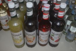 *4x Bottles of Assorted Monin Syrups: 1L Strawberry, 1L Peach, 1L Lemon, and 70cl Toasted