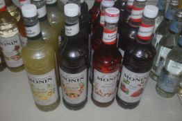 *4x Bottles of Assorted Monin Syrups: 1L Strawberry, 1L Peach, 1L Lemon, and 70cl Toasted