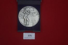 Large silvered commemorative medal, “N.C.G.S. Silver Jubilee 1989”, depicting a golfer, housed in