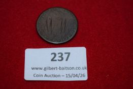 Love token. Victorian coin smoothed and engraved with stylised initials “M + W”.