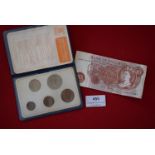 Britain’s first decimal coin set in wallet, together with a Bank of England ten shillings note.