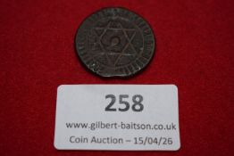 Islamic bronze coin, star design within circle; reverse with Arabic numerals and script. Worn.