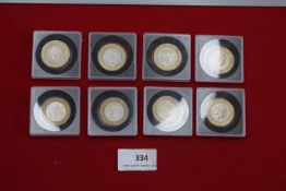 Collection of UK £2 coins, various commemorative types, all in protective cases.