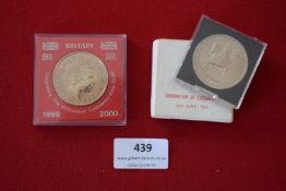 Pair of commemorative coins: 1999–2000 Millennium crown in case, and 1953 Elizabeth II Coronation