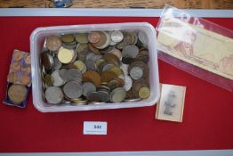 Mixed world coin accumulation in container, together with small group of additional items
