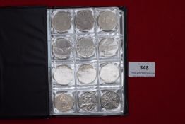 album of UK commemorative 50p coins including Olympic and Beatrix Potter issues, together with £2