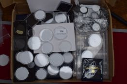 Quantity of coin collecting accessories including capsules, holders and storage boxes.