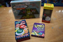 Selection of Travel Games Including Casio Set, Uno Flip, Yes No Buttons, and a Retro Blocks Game