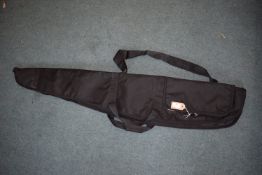 Black padded rifle slip with full-length zip, carry handles, shoulder strap and external accessory