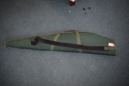 Single green canvas rifle slip with zip fastening and shoulder strap.