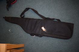 Black padded rifle slip with carry handles and shoulder strap.