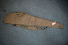 Green padded rifle slip with full-length zip, carry handles and adjustable shoulder strap.