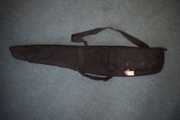 Black padded rifle slip with full-length zip, carry handles and shoulder strap, together with a