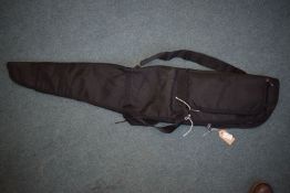 Black padded rifle slip with carry handles and shoulder strap, fitted external pocket.
