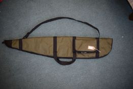 Green canvas rifle slip with black trim, carry handles, shoulder strap and external pocket.