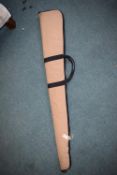 Tan padded rifle slip with black trim, full-length zip and carry handles.