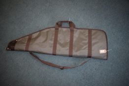 Padded green and brown rifle slip with full-length zip, carry handles and shoulder strap, the