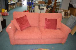 Red Upholstered Two Seat Sofa Bed with 4x Cushions