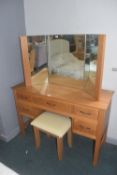 Solid oak five drawer dressing table with triple mirror and small stool