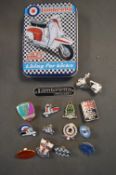 Lambretta tin containing various Lambretta badges etc