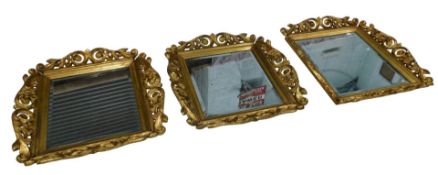 A set of three carved cherrywood Polish mirrors, in the rococo style, with heavily carved scroll