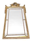 A gilt plastic wall mirror in Adam style, the crest inset with an oval print, 127cm high, 63cm wide.