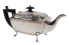 A George V silver teapot, with ebonised angular thumb mould handle and shaped knop, with plain