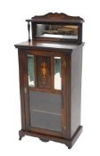 An Edwardian rosewood side or music cabinet, with an upper shelf, with inlaid back above mirror, and