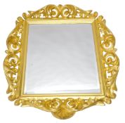 A 1970s Polish German carved cherrywood mirror, in the rococo style, with heavily carved scroll