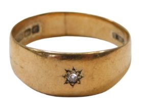 A 9ct gold wedding band, set with a single tiny diamond, in a star setting, Birmingham 1902, ring