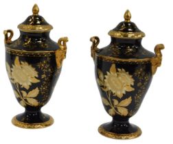 A pair of Wedgwood black Tonquin pattern vases, with ttwin ram's head handles, baluster form,