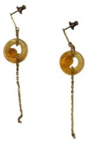 A pair of Lalique drop earrings, each with an amber coloured glass swirl, centred on a linked chain,