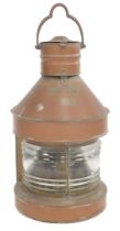A copper masthead ship's lantern, with a swing handle and masthead plaque, above a further plaque