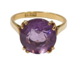 An amethyst single stone dress ring, the round brilliant cut amethyst 10.4mm diameter, in a four