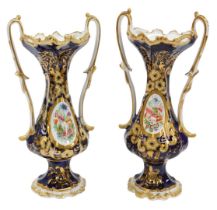 A pair of mid 19thC Staffordshire porcelain two handled vases, each decorated with floral sprays,