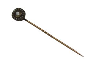 An Edwardian citrine and seed pearl stick pin, centred with an oval cut citrine surrounded by a
