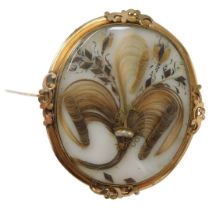 A late 19thC memorial brooch, the oval opaque glass panel set with a Prince of Wales feather