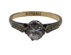 A silver stone set dress ring, set with an imitation diamond, in a raised claw silver setting,