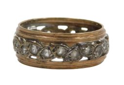 An eternity band, with leaf design set with CZ stones, on white metal centre on a yellow metal outer