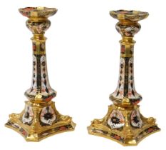 A pair of Royal Crown Derby porcelain candlesticks decorated in the Old Imari pattern, gold ground,