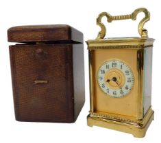 An early 20thC brass cased carriage clock, with an ivory porcelain dial having Arabic numerals, four