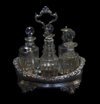 A George IV and later silver cruet stand, of oval form, the border decorated with scrolls and