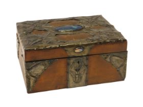 An early 20thC Arts & Crafts sewing box, the hinged lid overlaid with leather and pressed pewter