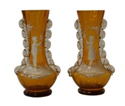 A pair of Victorian amber glass vases, with crimped glass ornamentation, and painted with Mary